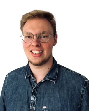 Junger Mann mit Brille und lächelndem Gesicht, trägt ein Jeanshemd. Hintergrund ist einfarbig weiß.