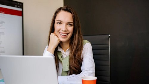 Employee in Supply Chain Management smiles at the camera.